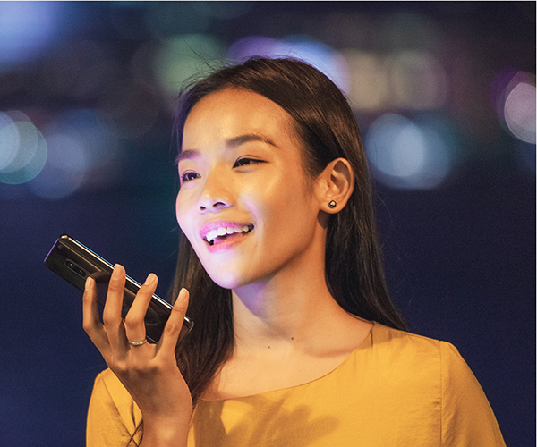 woman speaks to a smartphone